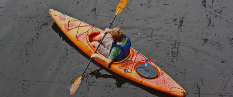 young man kayaking on a river