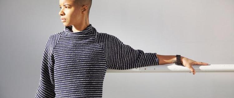 Young man looking to the side with arm on railing