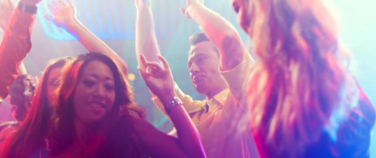 Photo of people dancing in a nightclub.