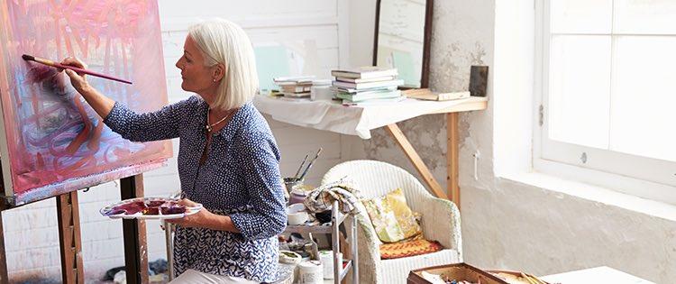 A woman painting in her studio.