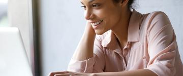 A woman looking at a laptop