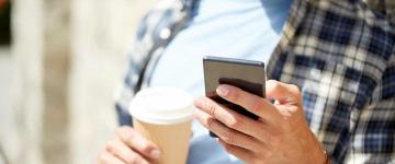 Man on phone with coffee