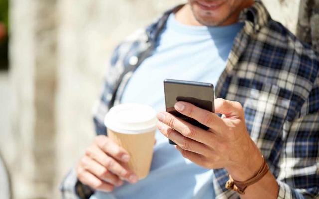 Man on phone with coffee