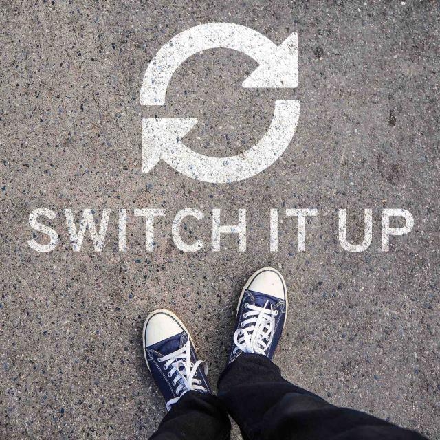 image of person's shoes with text "switch it up" underneath two arrows pointing in a circle