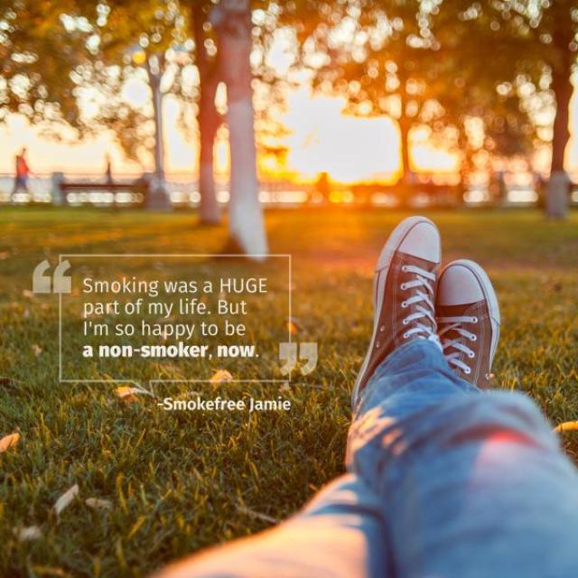 "Someone wearing jeans and sneakers lounges in the grass at a park. The text says, "Smoking was a HUGE part of my life. But I'm so happy to be a non-smoker, now" and is attributed to Smokefree Jamie."