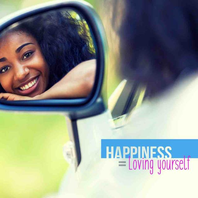 Photo of a young black woman looking at herself in a car side view mirror with text saying "Happiness = Loving Yourself"